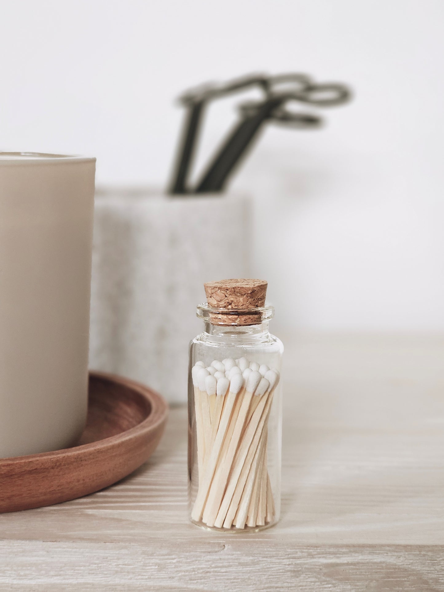 a small clear jar with cork lid holding artisan white tipped matches